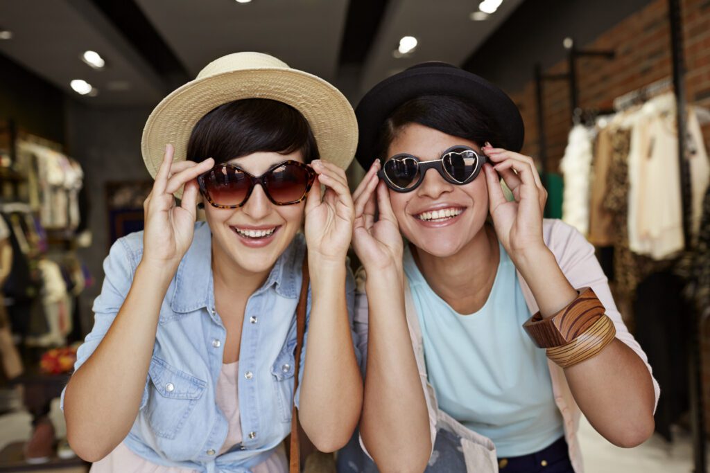 two women buying sunglasses with their insurance plan.
