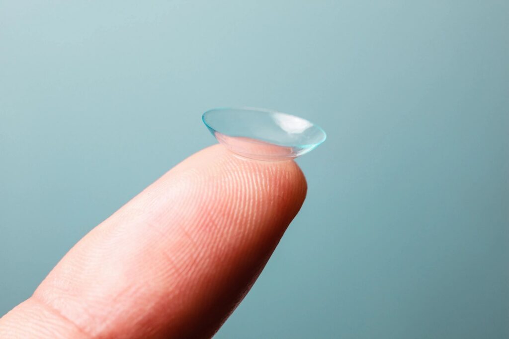 Close-up of an RGP contact lens on a fingertip, used for specialty lens fittings in Honolulu